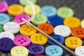 Colorful buttons on work table close up. Clothing sewing