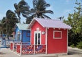 Colorful cabanas and lounge chairs on the beach in Princess Cays