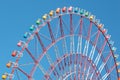 Colorful cabins on a Ferris wheel, blue sky