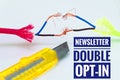 Colorful cables that were patched separately and makeshift and a craft knife with inscription Newsletter Double Opt-In