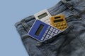 Colorful calculator in a pocket of blue jeans Royalty Free Stock Photo