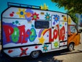 Colorful camper with flowers and the text ''peace and love'' on the street