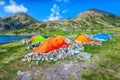 Colorful camping tents near alpine lake in the mountains, Romania Royalty Free Stock Photo