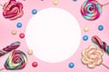 Colorful candies and candy bars on pink background with copyspace blank area Royalty Free Stock Photo