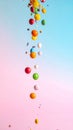 Colorful Candies Falling on Pastel Pink and Blue Background Royalty Free Stock Photo