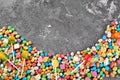 Colorful candies on grey textured background, top view Royalty Free Stock Photo