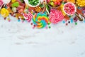 Colorful candies, jelly and marmalade on a white wooden background. Sweets. Top view.