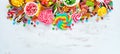 Colorful candies, jelly and marmalade on a white wooden background. Sweets. Top view.