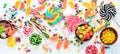 Colorful candies, jelly and marmalade on a white wooden background. Sweets. Top view.