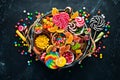 Colorful candies, jelly and marmalade in a wooden box. Sweets. On the old background. Top view.