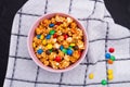 Colorful candies and salty popcorn mix in ceramic plate on white napkin. Royalty Free Stock Photo