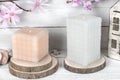 Colorful candle of various shapes on wooden background. Scented candle.