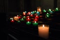 Colorful candles burning in the dark. Background or wallpaper. Royalty Free Stock Photo