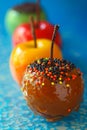 Colorful Candy Apples with Sprinkles on a Vibrant Blue Background for Festive Occasions and Parties