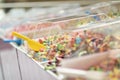 colorful candy, healthy jelly sweets in plastic boxes on market stand in confectionery