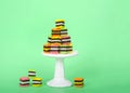 Colorful candy licorice squares on pedestal green background Royalty Free Stock Photo