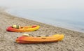 Colorful canoe boats on sea shore in thick fog