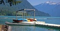 Colorful Canoes on Dock of Mountain Lake Royalty Free Stock Photo