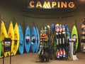 Colorful canoes and liftjackets for sale at store