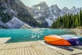 Colorful canoes on a wooden deck on the shore of Moraine Lake in the Canadian Rockies Royalty Free Stock Photo
