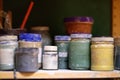 Colorful cans of paint on the shelf in the workshop Royalty Free Stock Photo