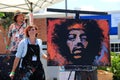 Young woman painting on large canvas during Food festival, The Lumberyard, Laguna Beach, California, 2016