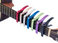 Colorful capo on guitar fingerboard, white background Royalty Free Stock Photo