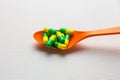 Colorful capsules pills on a spoon Royalty Free Stock Photo