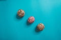 Colorful, caramelized, chocolate balls with crumbs on them isolated on a blue background