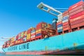 Colorful cargo shipping containers stacked aboard of container ship Maersk Line Royalty Free Stock Photo