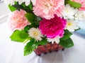 Colorful carnation flower basket for visiting patience on bed