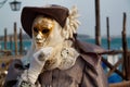 Colorful carnival beige-gold mask and costume at the traditional festival in Venice, Italy