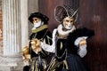 Colorful carnival black-white-gold mask and costume at the traditional festival in Venice, Italy