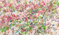 Colorful carnival confetti and serpentines on wooden background, top niew Royalty Free Stock Photo