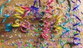 Colorful carnival confetti and serpentines on wooden background, top niew Royalty Free Stock Photo