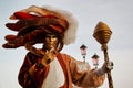 Colorful carnival gold-beige-brown mask and costume at the traditional festival in Venice, Italy Royalty Free Stock Photo