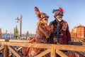 Colorful carnival masks against gondolas at a traditional festival in Venice, Italy Royalty Free Stock Photo