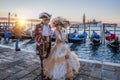 Colorful carnival masks at a traditional festival in Venice against gondolas, Italy Royalty Free Stock Photo