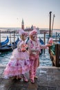 Colorful carnival masks at a traditional festival in Venice against gondolas, Italy Royalty Free Stock Photo