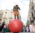 Colorful carnival parade down the street with clowns and jugglers