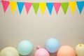 Colorful carnival or party frame of balloons, streamers and confetti on grey background. Space for text Royalty Free Stock Photo