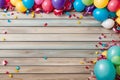 Colorful carnival or party frame of balloons, streamers and confetti on rustic wood