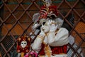 Colorful carnival red-gold mask and costume at the traditional festival in Venice, Italy