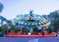 Colorful carousel spinning in the amusement park at night