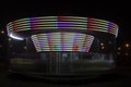 A colorful carousel spinning in the park with a long exposure time