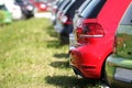 Colorful cars parked on the grass. Red and green automobiles Royalty Free Stock Photo