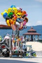 Colorful cartoon character balloon and kid toy hawker by street at Hop-On Hop-Off Boat pier in Sun Moon Lake