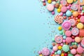 A colorful cascade of various sweets and candies on a turquoise background.