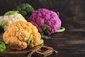 Colorful cauliflower. Various sort of cauliflower on old wooden background. Purple, yellow, white and green color cabbages. Royalty Free Stock Photo