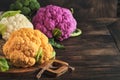 Colorful cauliflower. Various sort of cauliflower on old wooden background. Purple, yellow, white and green color cabbages. Royalty Free Stock Photo
